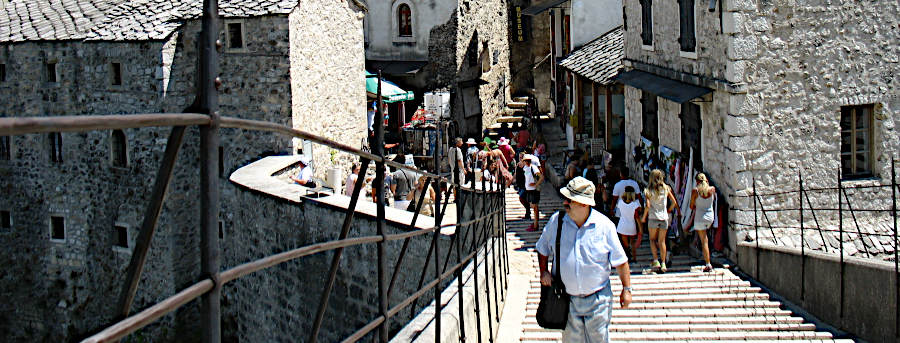  Looking back toward restaurants and shops while standing at the peak of the Mostar Bridge